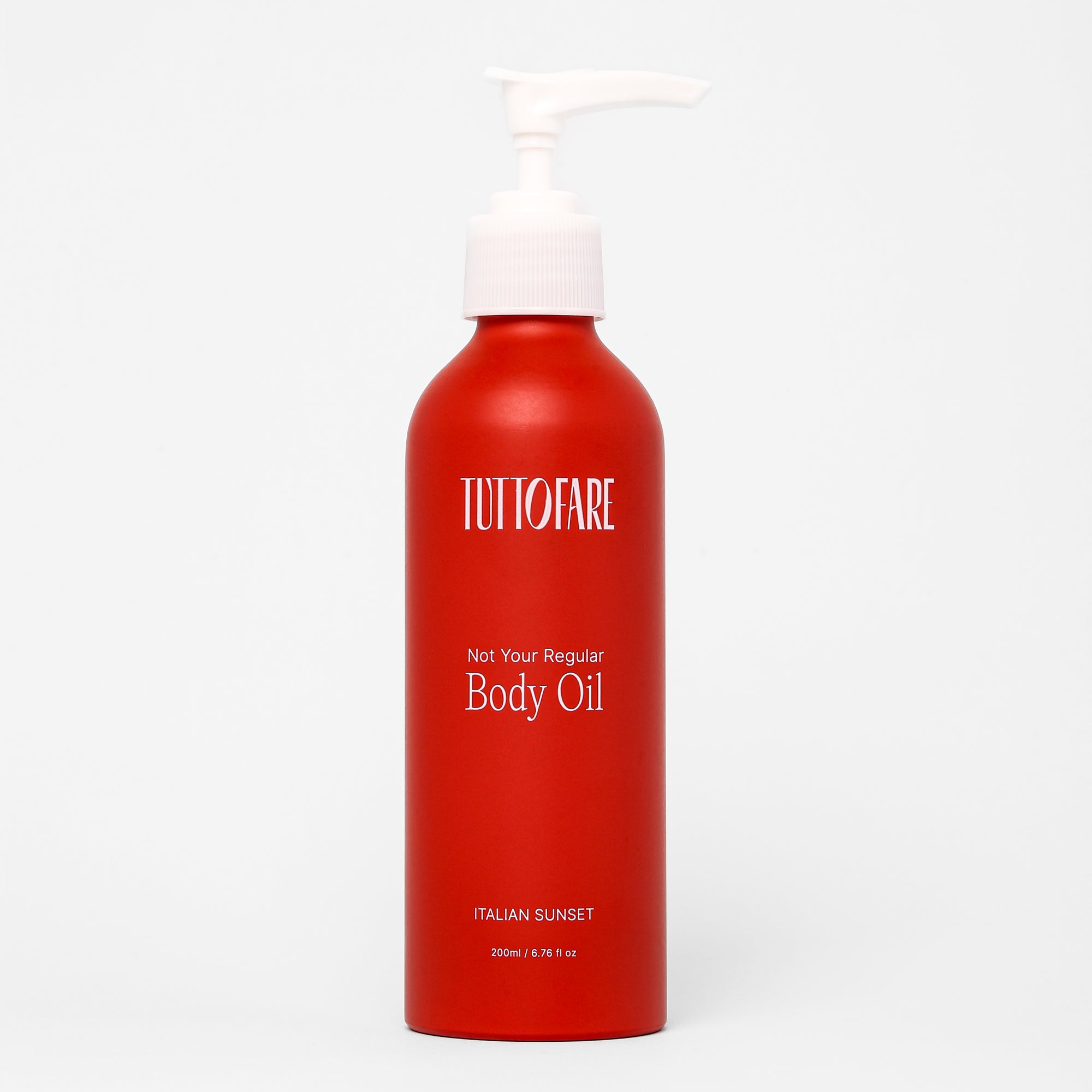 A red bottle with a white pump dispenser labeled 'TUTTOFARE Not Your Regular Body Oil' with text indicating it's an Italian Sunset scent, 200ml in size. Tallow Body Oil with Blood Orange, Tonka and Buriti.